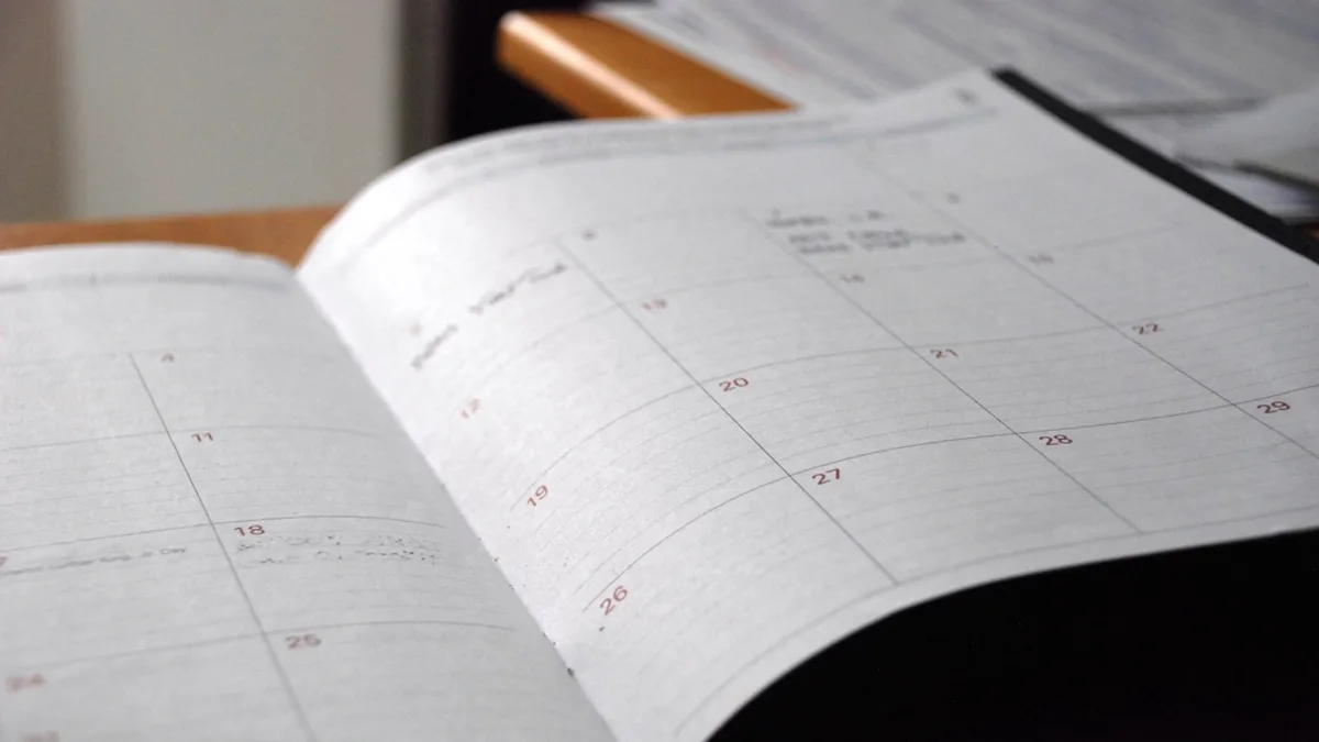 An open planner calendar on a desk, waiting to be updated